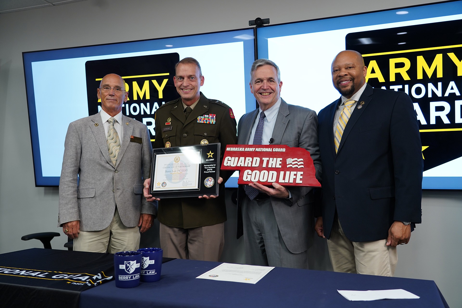 several representatives from the army pays program, the army, and berry law pose for a photo at the recent signing ceremony